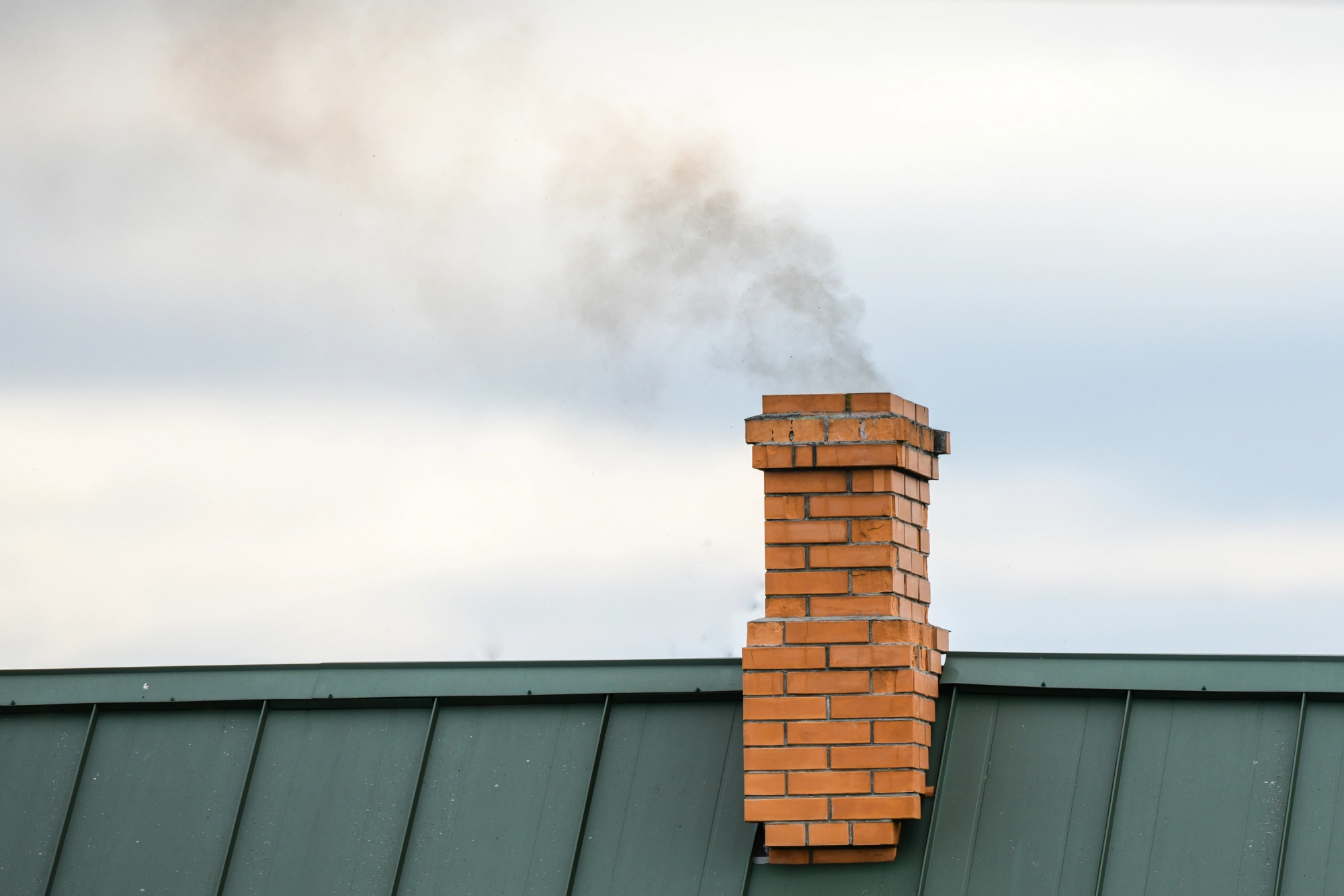 smoke-from-chimney-heating-smoke-billowing-coming-out-house-chimney-against-blue-sky-background