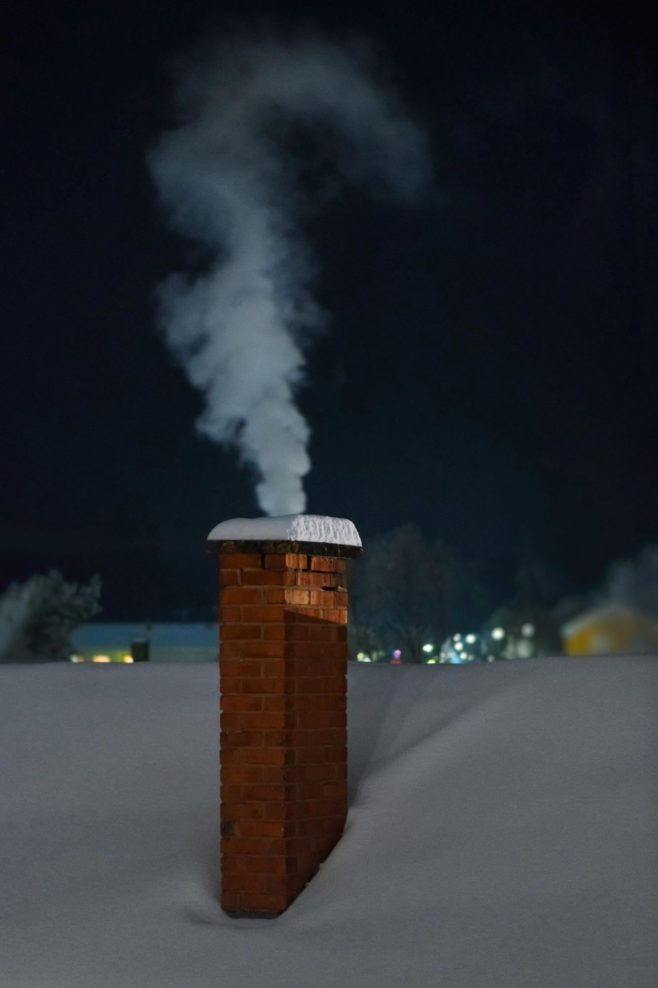 Chimney with white smoke during an cold winter evening